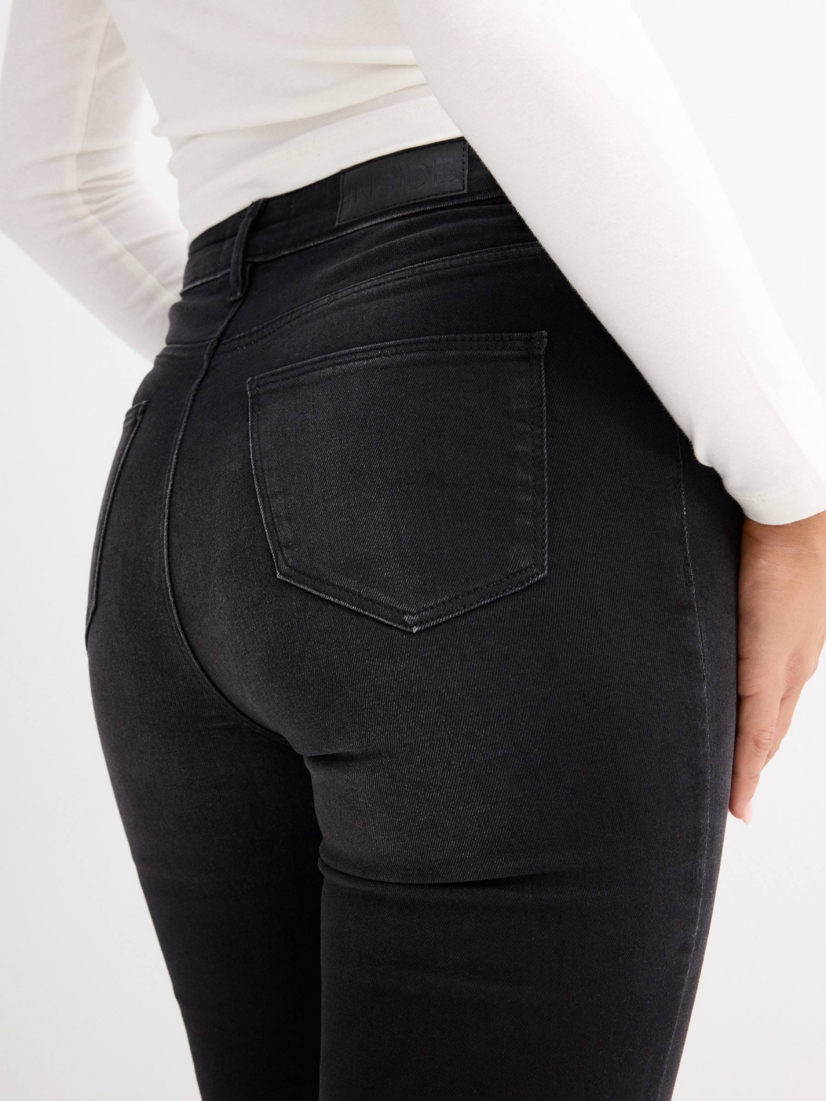 Black high rise skinny jeans black detail view