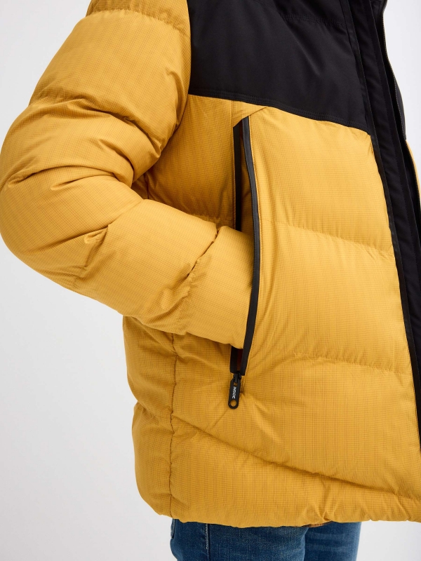 Block color quilted coat yellow detail view