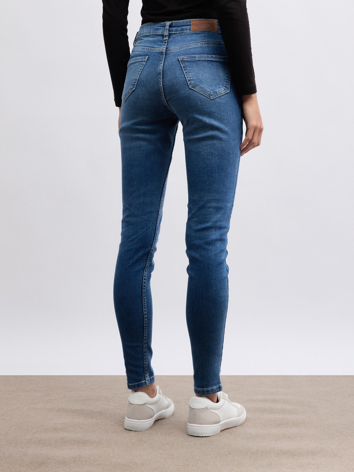 Denim skinny jeans medium rise blue middle back view