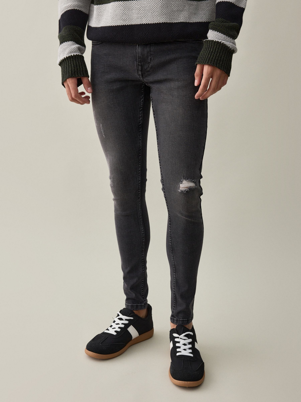 Black super skinny jeans with ripped black middle front view