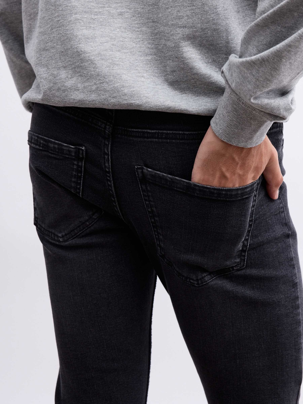 Dark denim skinny jeans black detail view