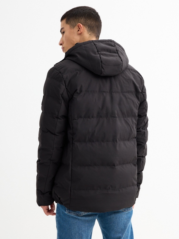 Black padded jacket black middle back view