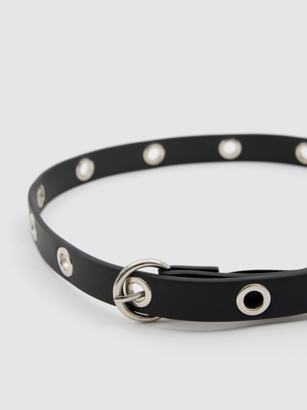 Thin belt with perforated outline. black detail view