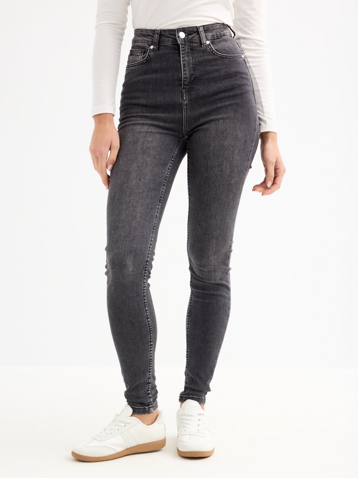 High-waisted skinny jeans with ripped black middle front view