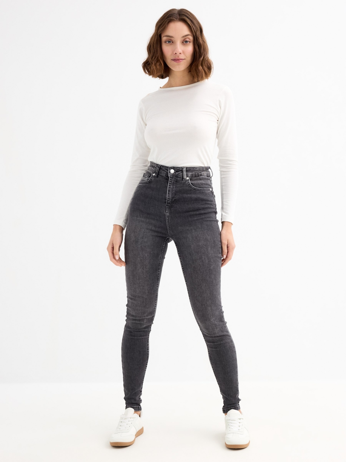 High-waisted skinny jeans with ripped black general front view