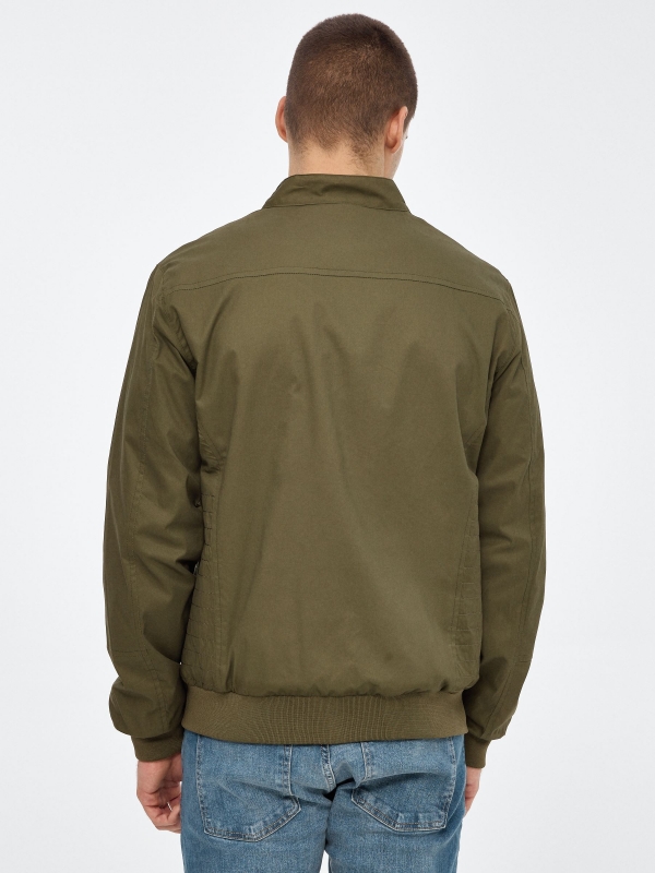 Black nylon jacket green middle back view