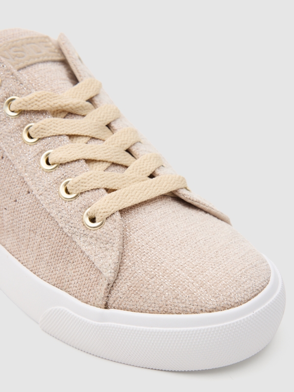 Natural canvas sneaker sand detail view