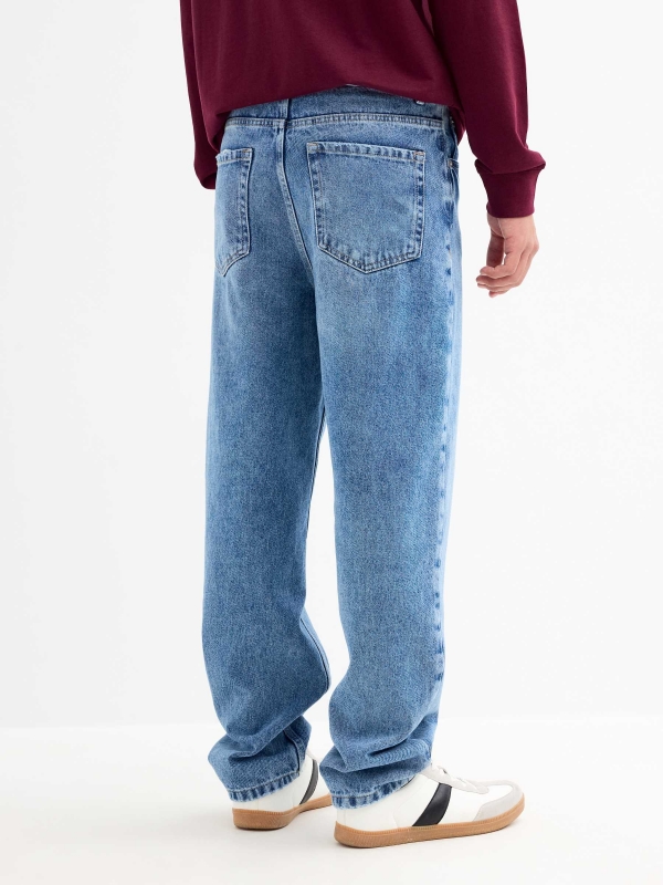 Blue baggy jeans with frayed blue middle back view