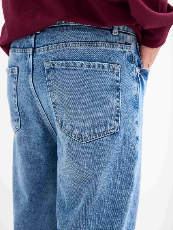 Blue baggy jeans with frayed blue detail view