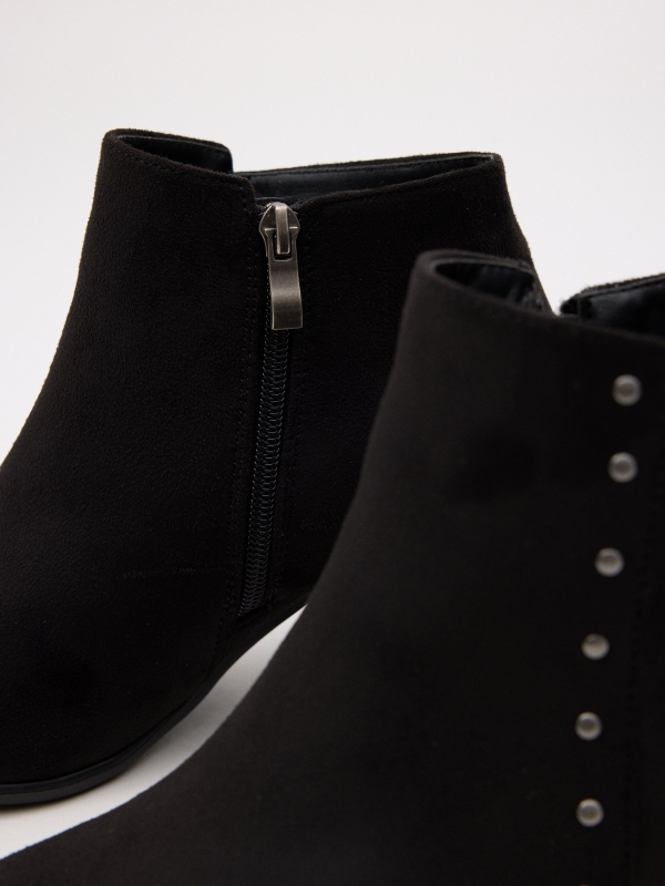 Heeled ankle boots with studs black detail view