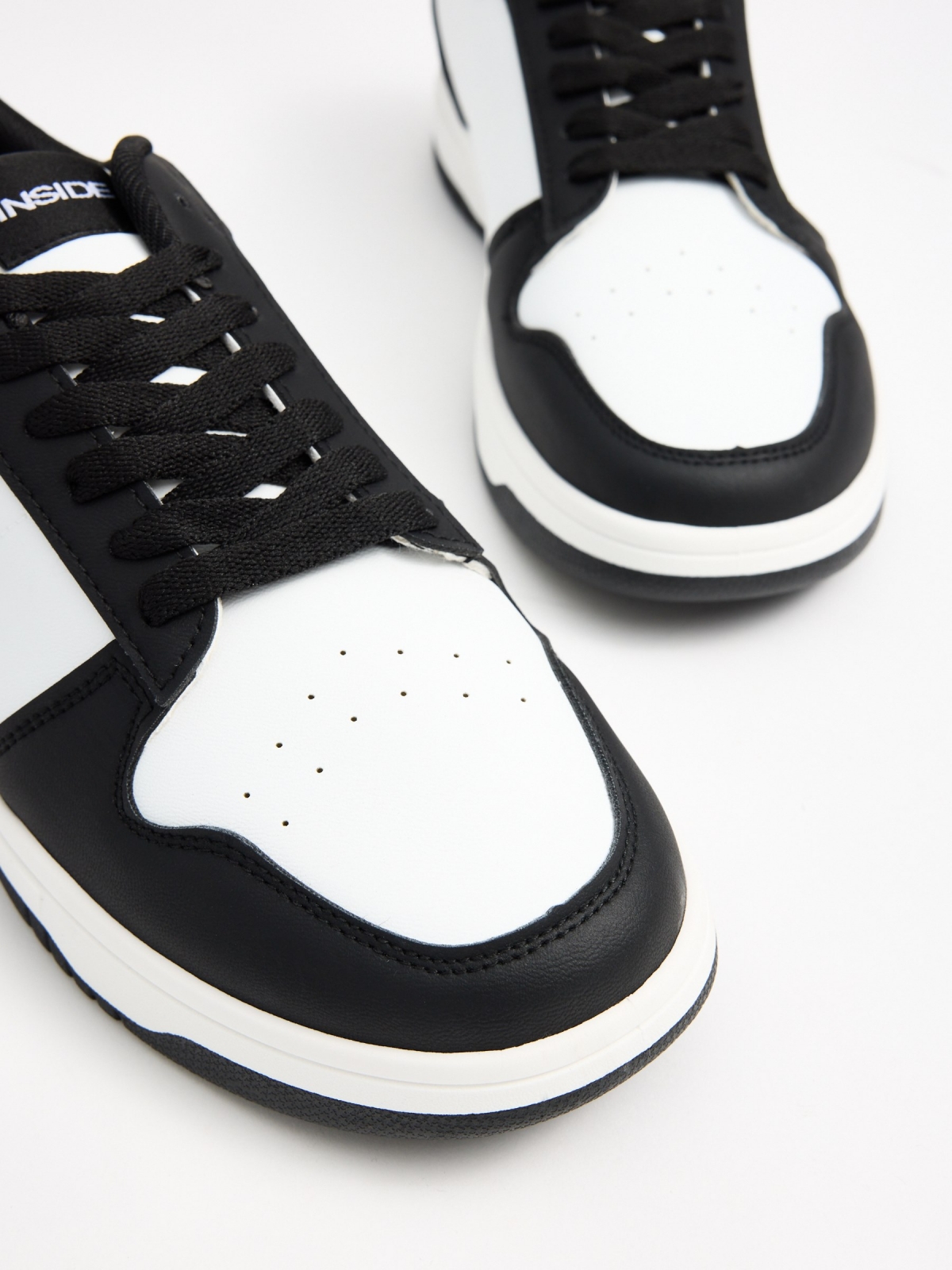 Black and white combined sneaker white detail view