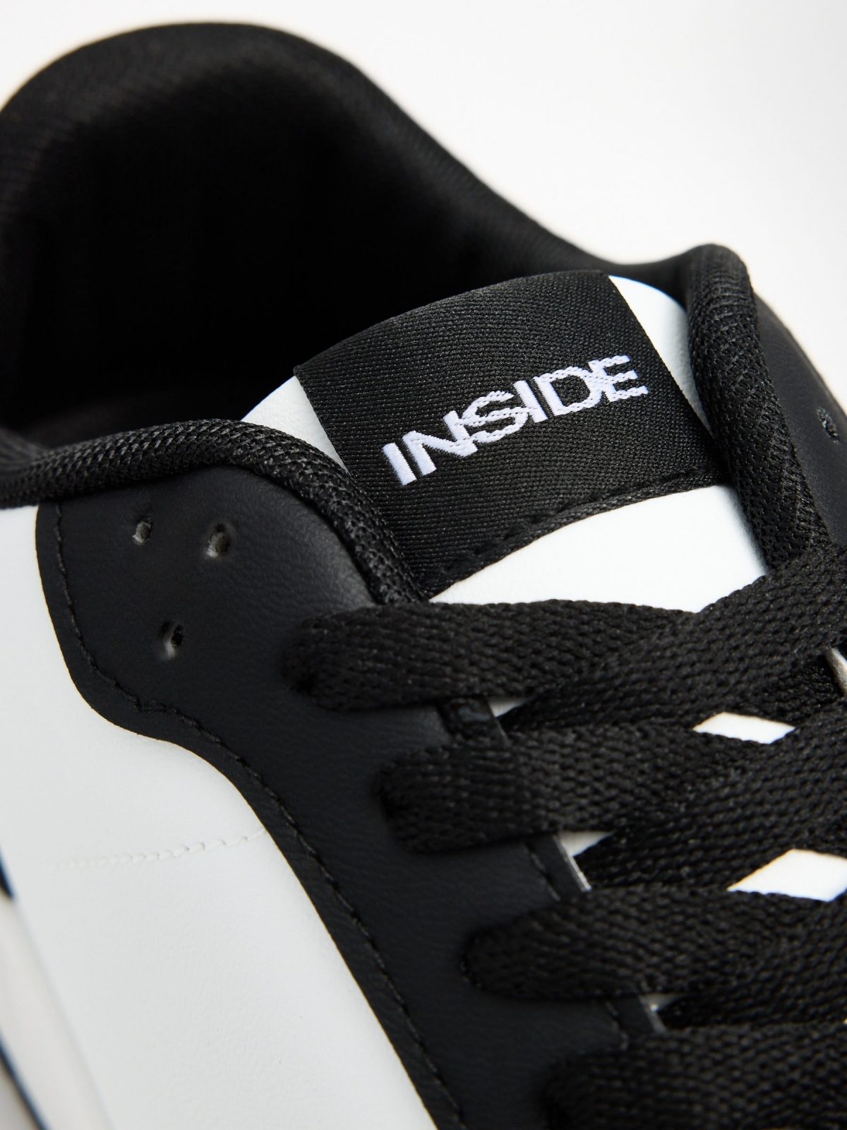 Black and white combined sneaker white detail view