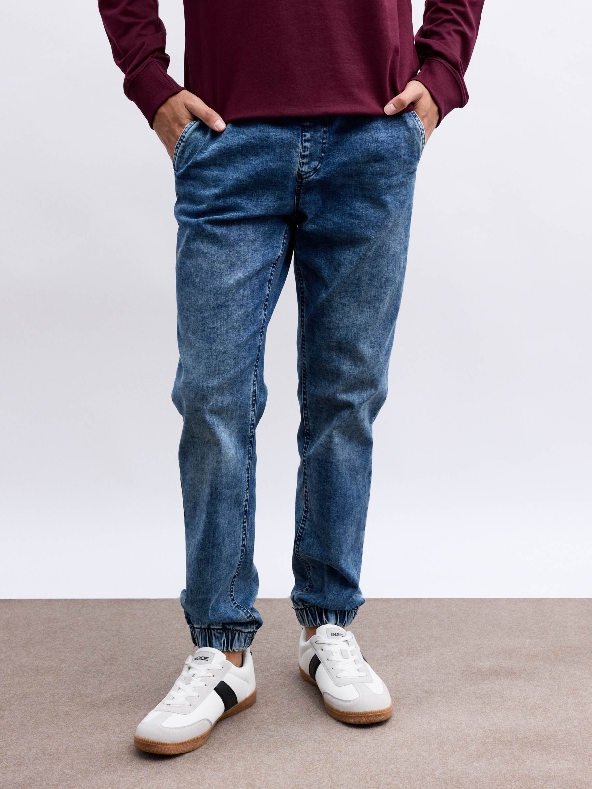 Denim jogger pants with rips blue middle front view