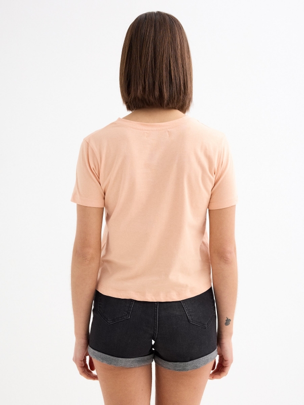 Wears Boots T-shirt peach middle back view