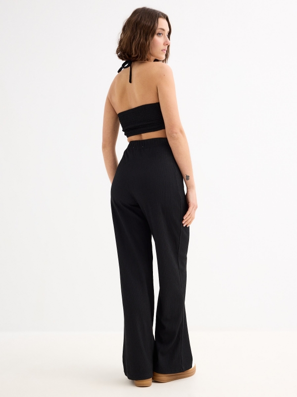 Halter jumpsuit knotted neck black three-quarter back view