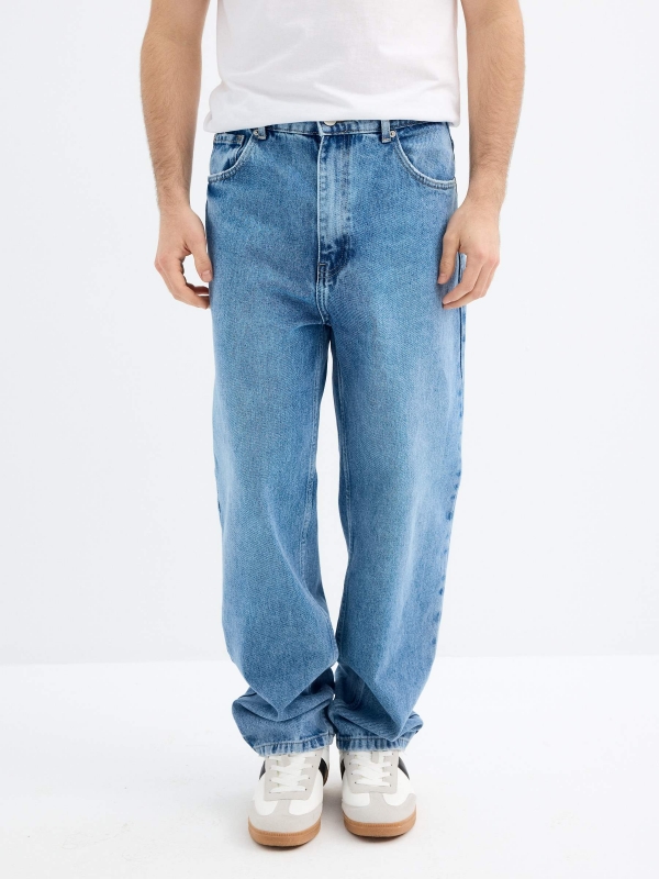 Blue baggy jeans with frayed blue middle front view