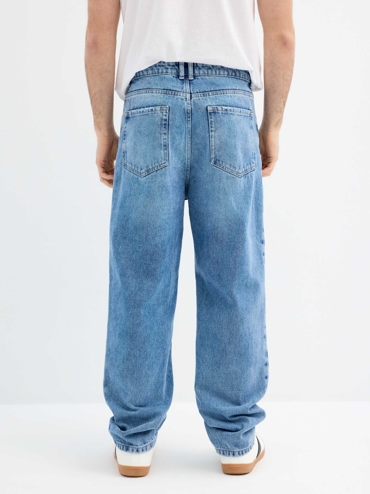 Blue baggy jeans with frayed blue middle back view