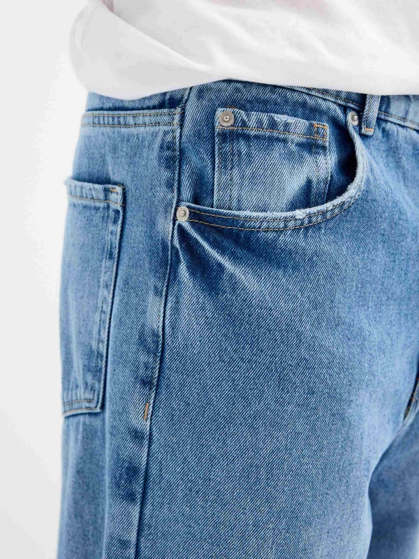 Blue baggy jeans with frayed blue detail view