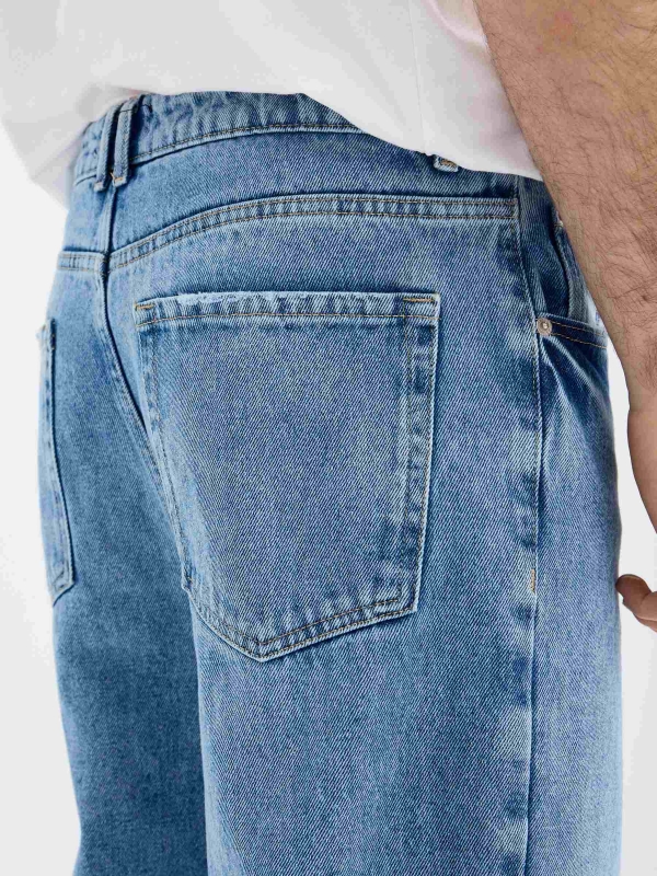 Blue baggy jeans with frayed blue detail view