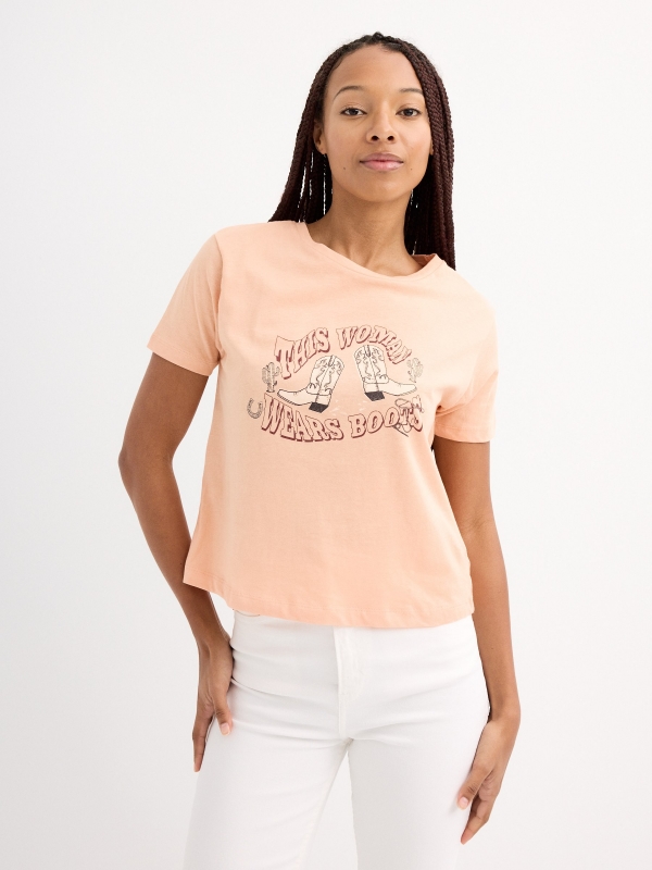 Wears Boots T-shirt peach middle front view