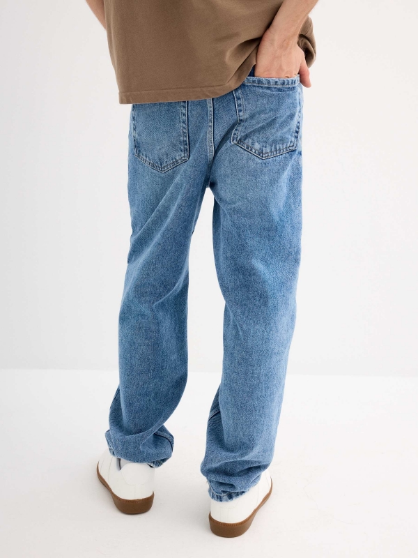 Blue baggy jeans with frayed blue middle back view