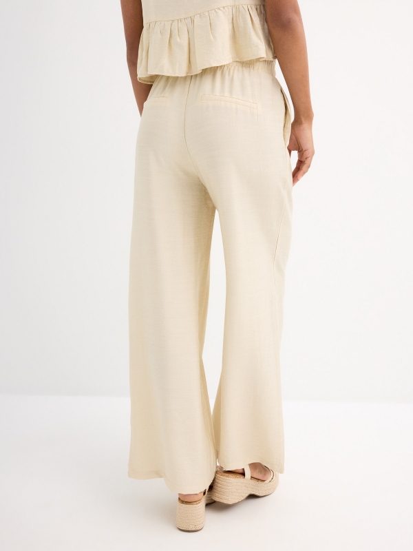 Fluid sand pants sand middle back view