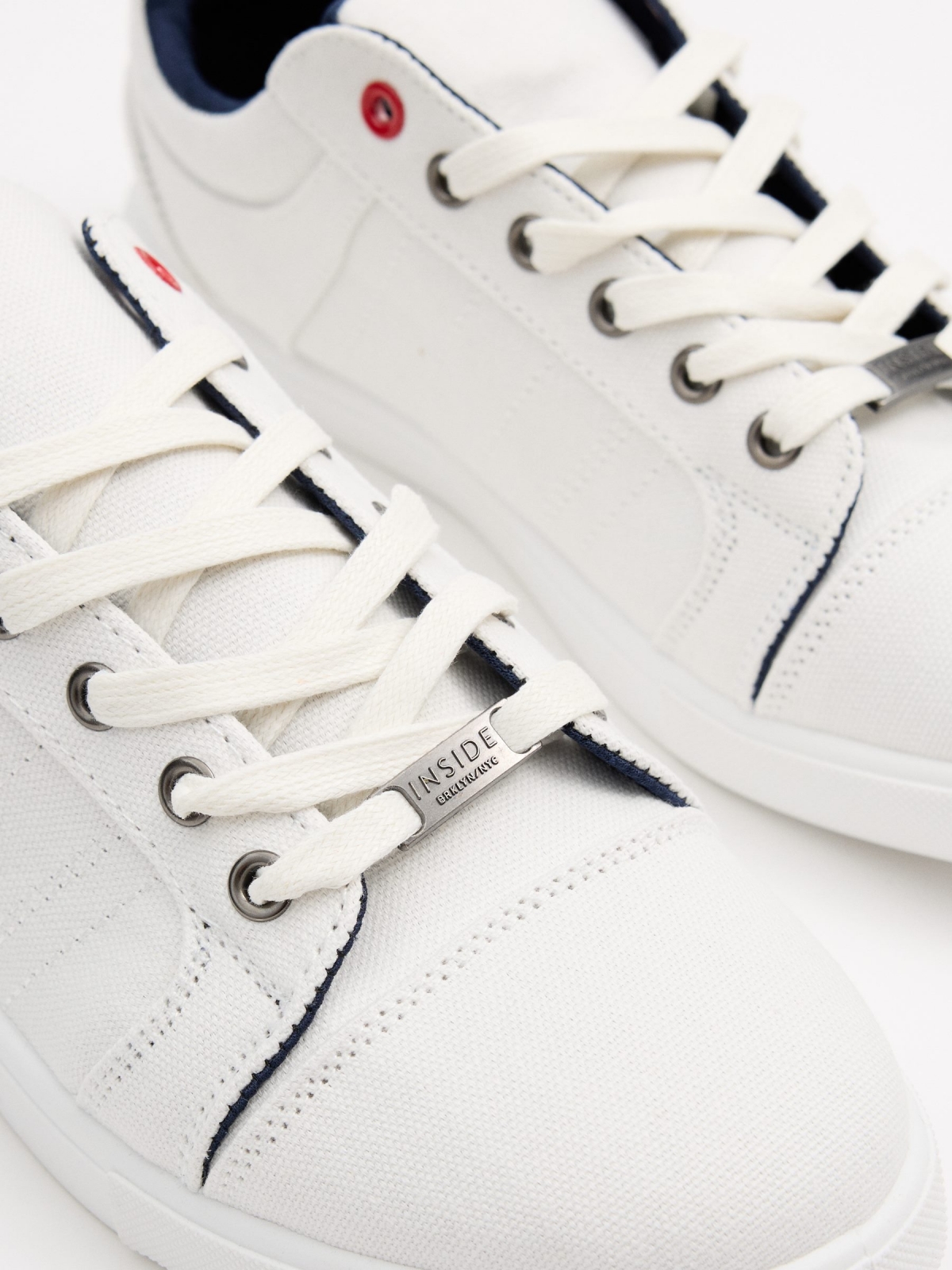 White canvas sneakers white detail view