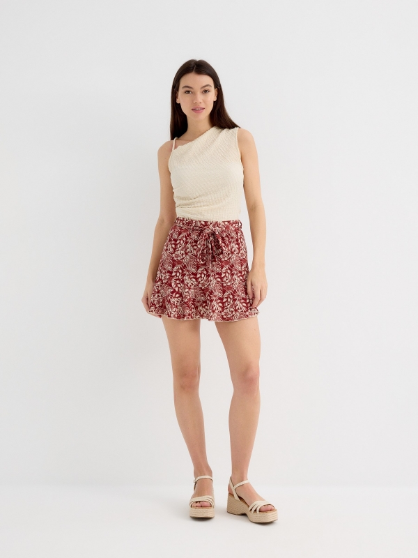Asymmetric top with textured relief sand general front view