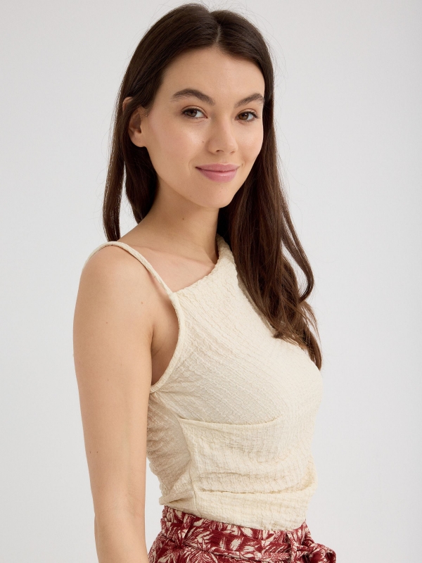 Asymmetric top with textured relief sand detail view