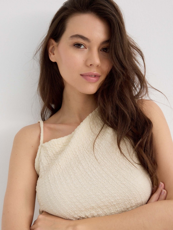 Asymmetric top with textured relief sand detail view