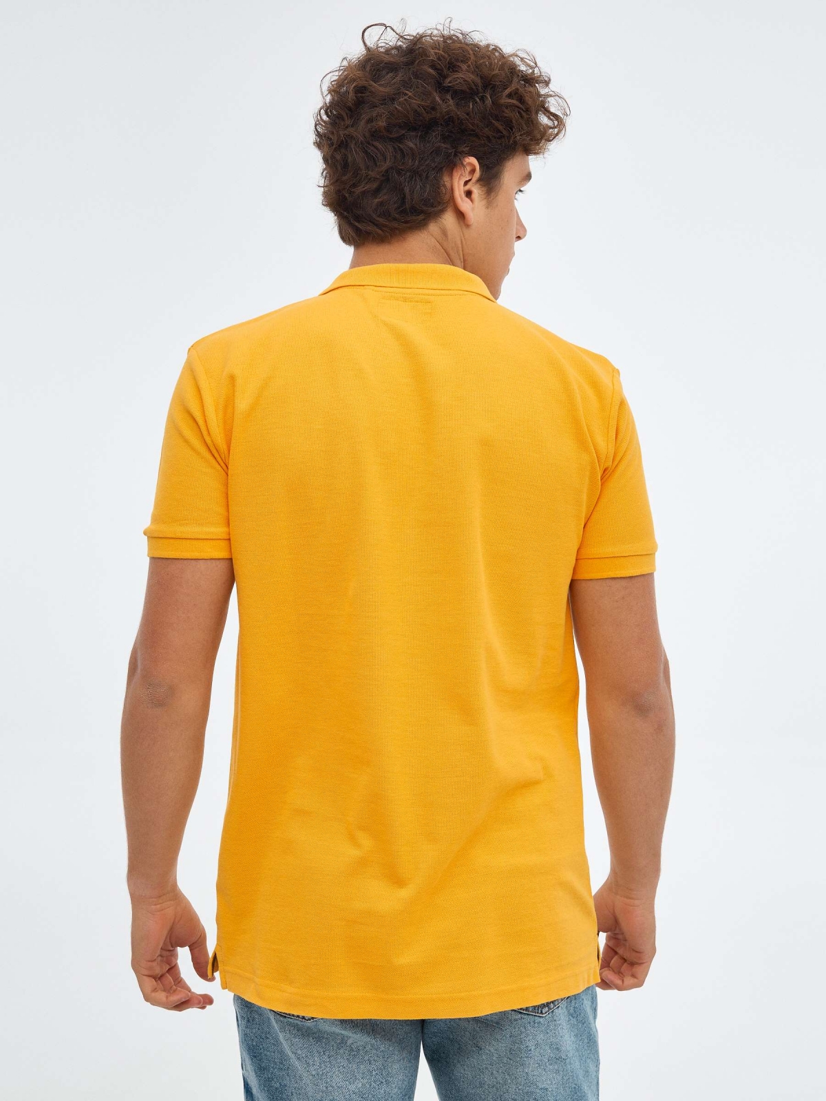 Polo básico logo grabado ocre vista media trasera