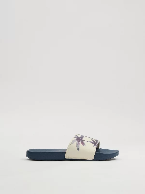 Flip-flops for palm trees sand detail view