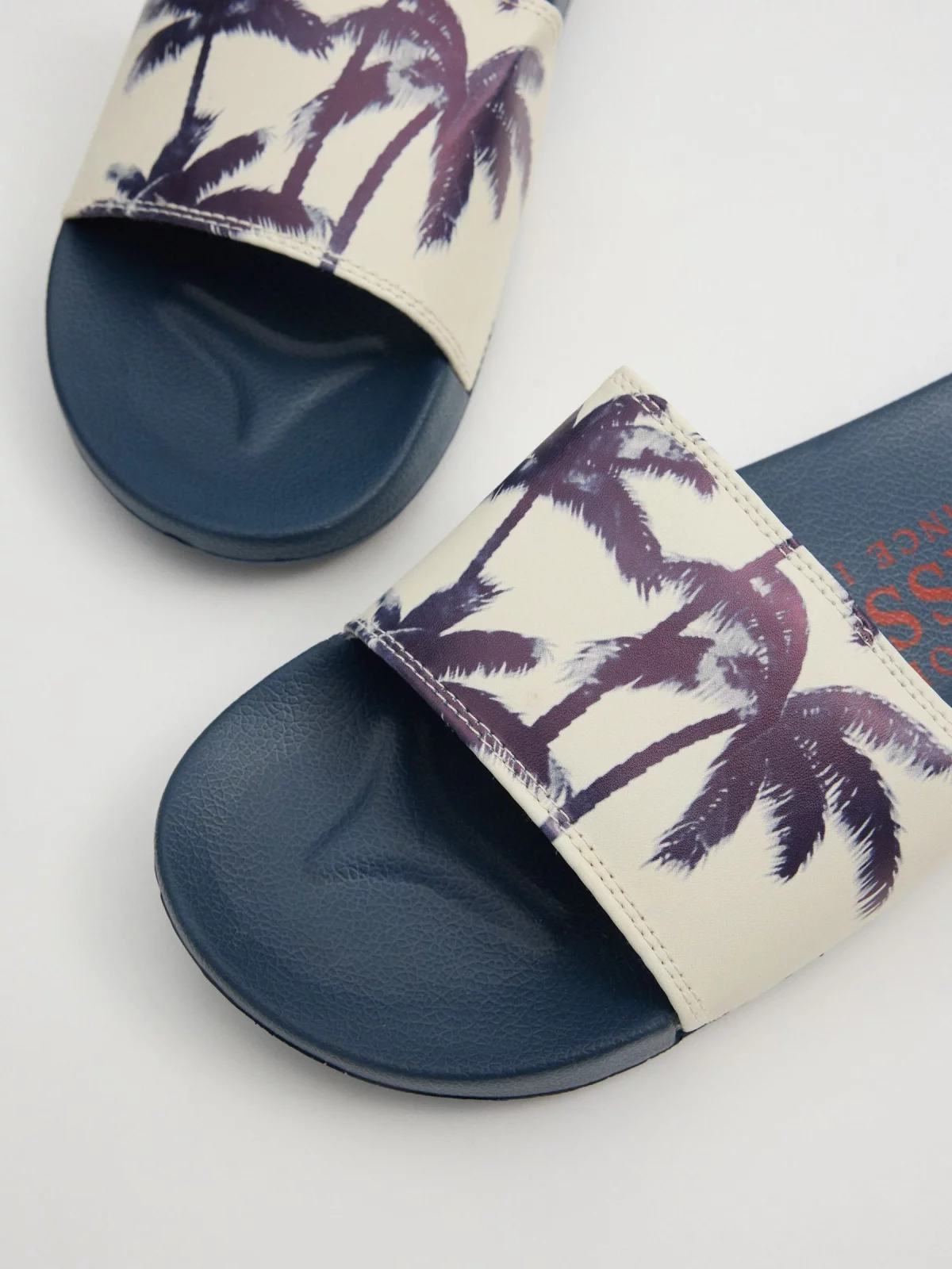 Flip-flops for palm trees sand detail view