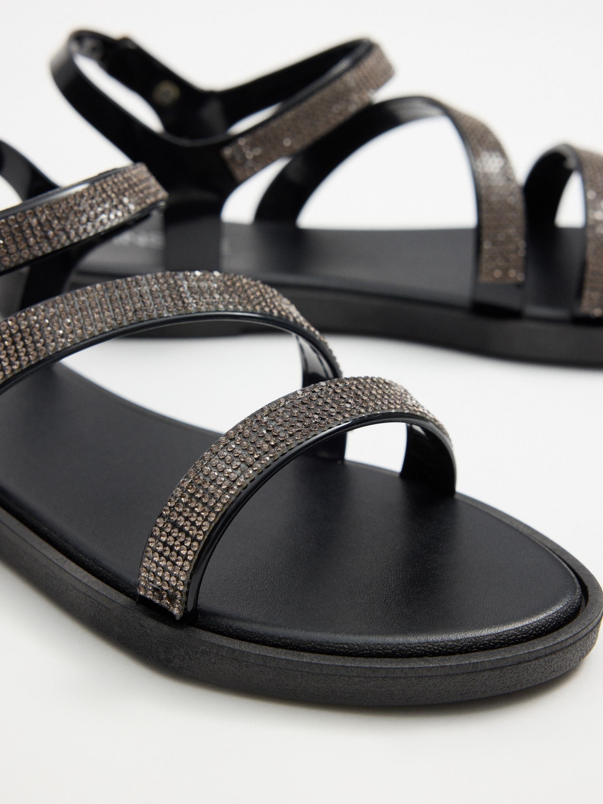 Black shiny strap sandal black with a model