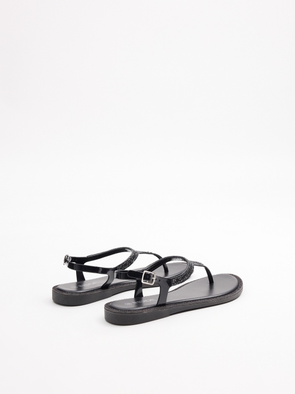 Flat toe sandal with shiny details black 45º back view