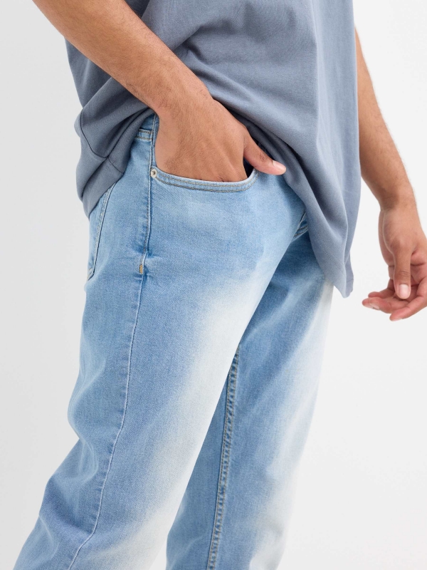 Light blue slim jeans with a worn effect blue detail view