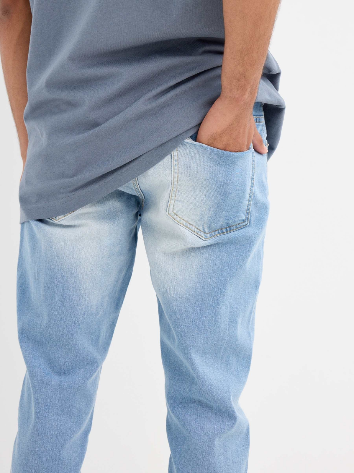 Light blue slim jeans with a worn effect blue detail view