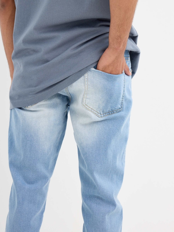 Light blue slim jeans with a worn effect blue detail view