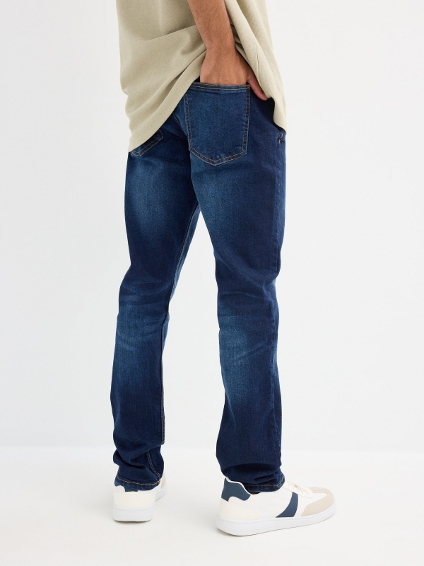 Dark blue slim jeans with stitching blue middle back view