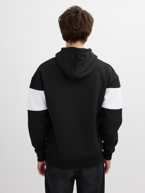 White and black color block hoodie black middle back view