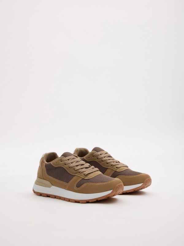 Zapatilla deportiva combinada beige crudo vista frontal 45º