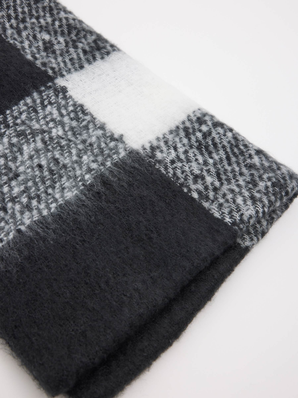 White and black checkered scarf with fringes black folded view