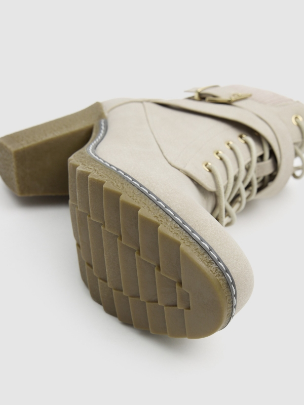 Lace-up heeled boot with crossed straps raw detail view