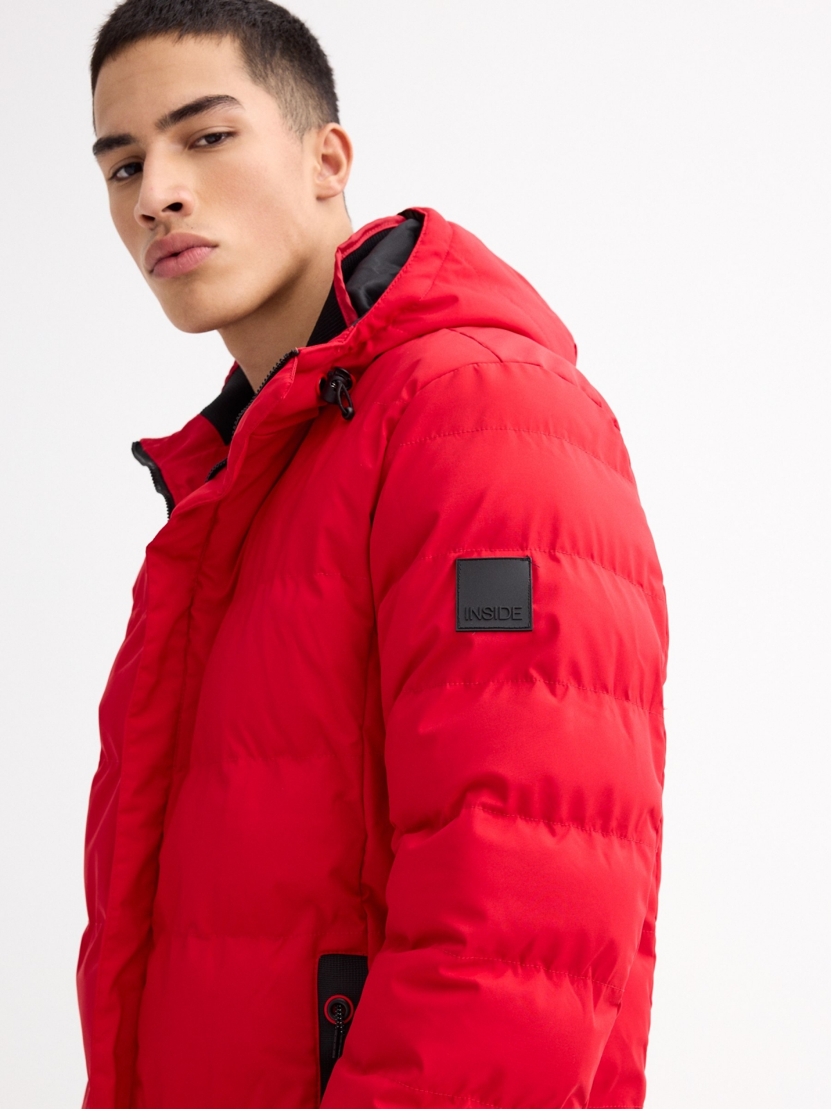 Black padded jacket red detail view