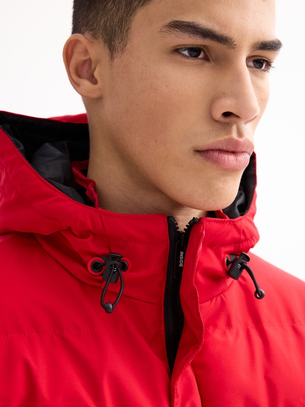 Black padded jacket red detail view