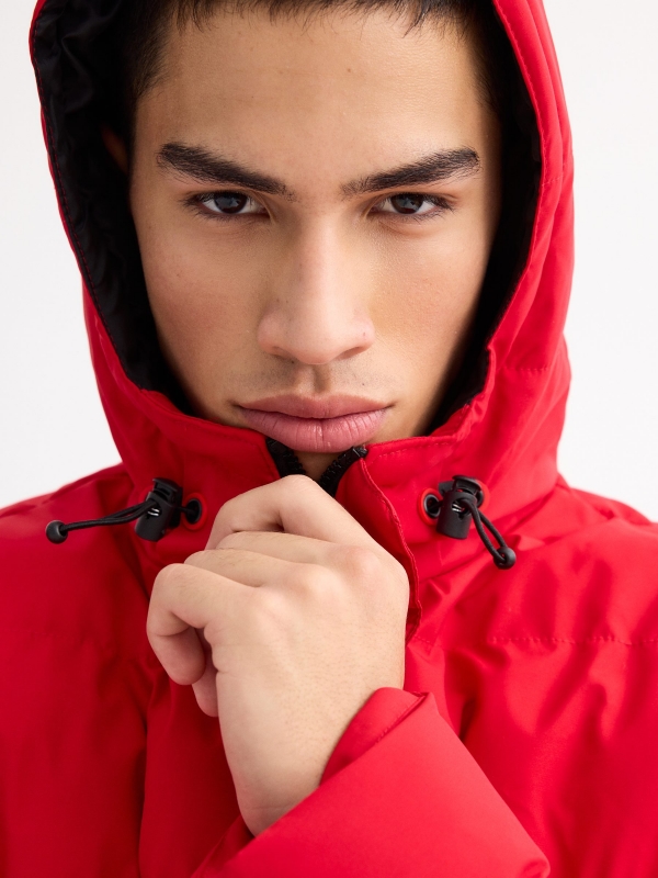 Black padded jacket red detail view