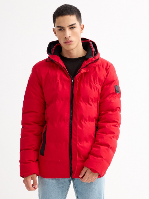 Black padded jacket red detail view