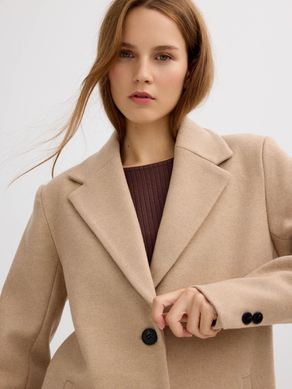 Beige cloth coat sand detail view