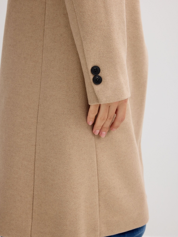 Beige cloth coat sand detail view