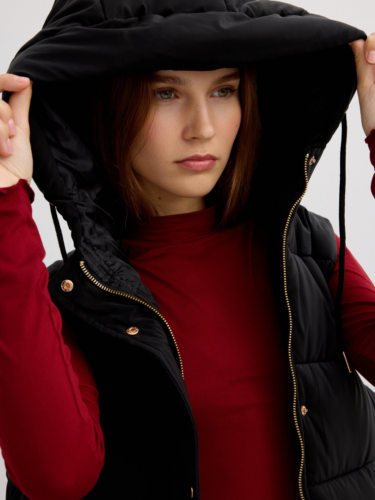 Long padded vest with hood black detail view
